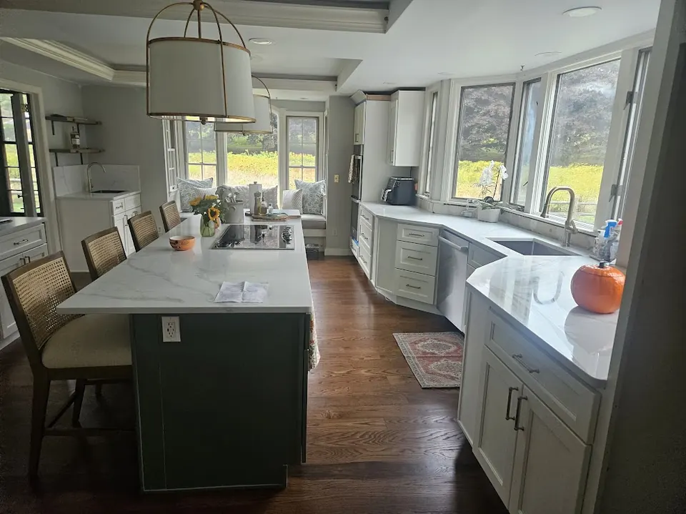 Weston kitchen after remodel with quartz island and dark green base