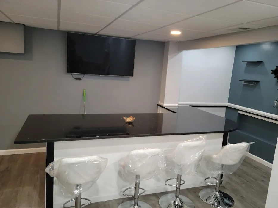 Finished basement bar with black granite