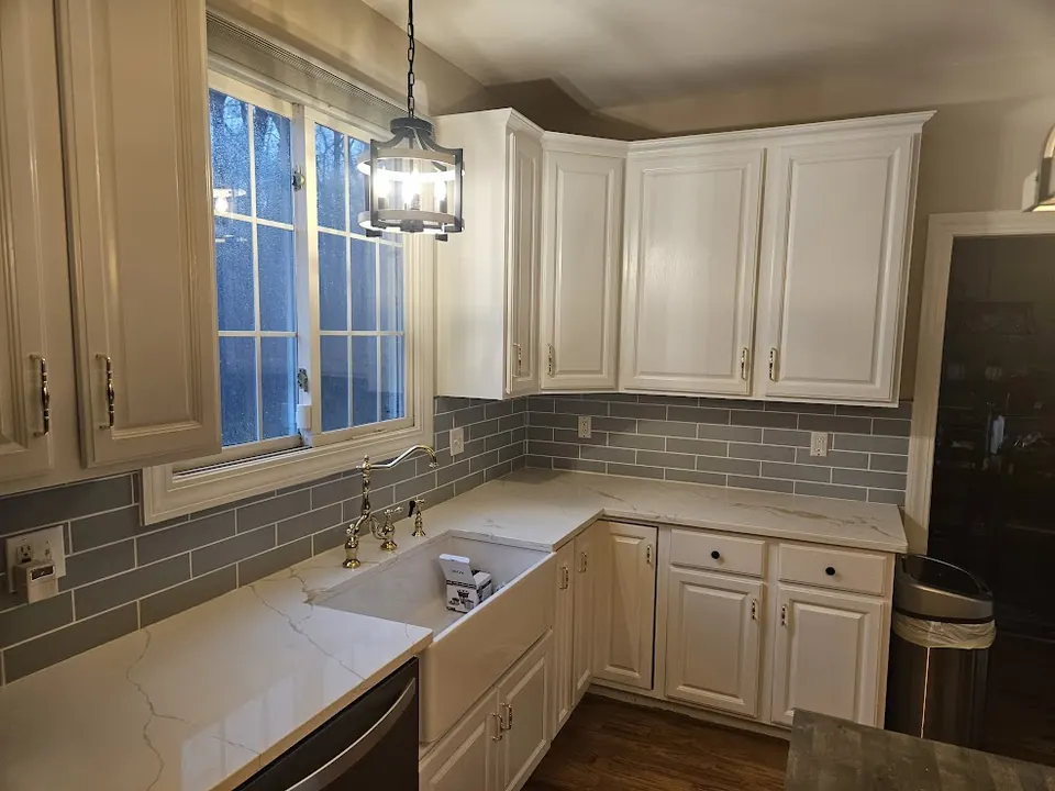 White kitchen with farmhouse sink and subway tile