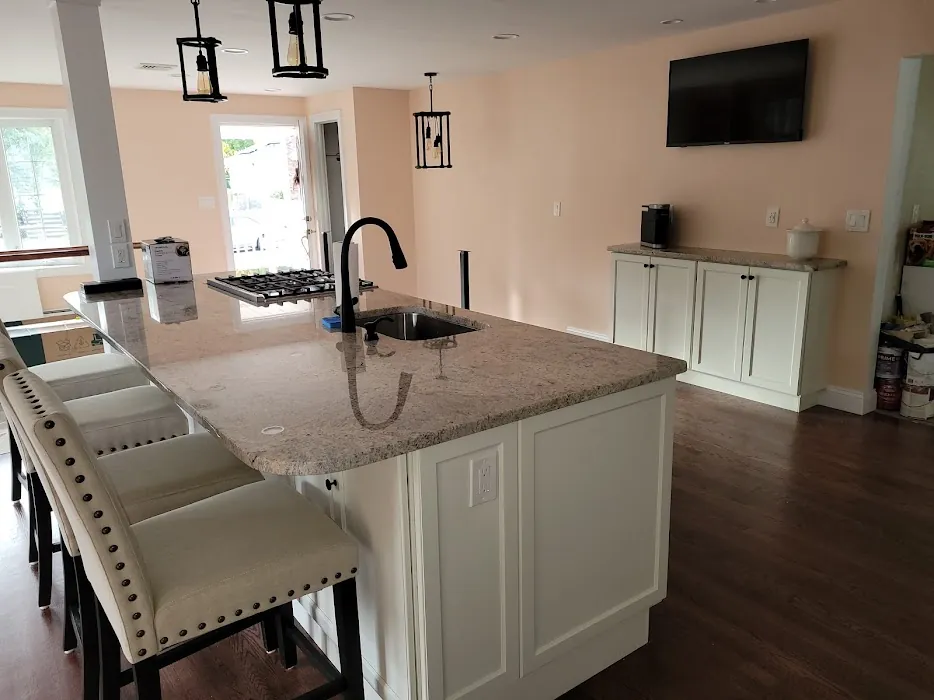 White kitchen with granite island and bar stools