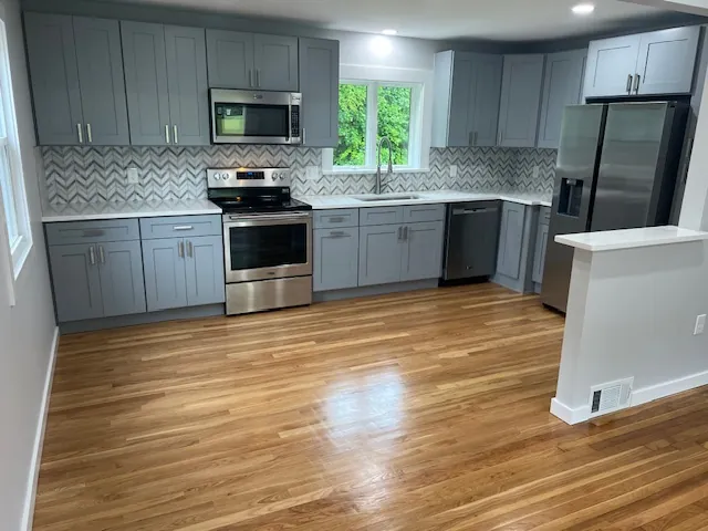Gray shaker kitchen with stainless appliances