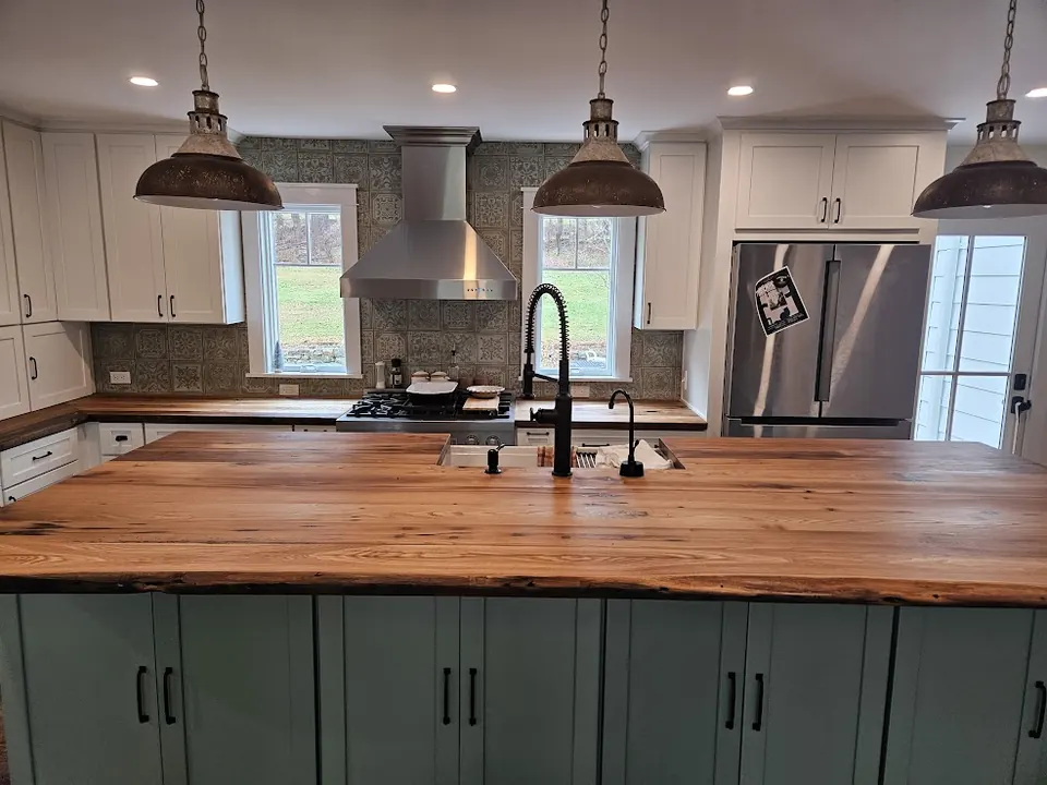 Sage green kitchen island with live-edge butcher block top