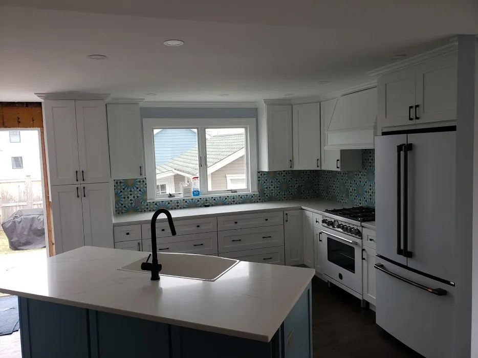 Two-tone kitchen with blue island and white cabinets