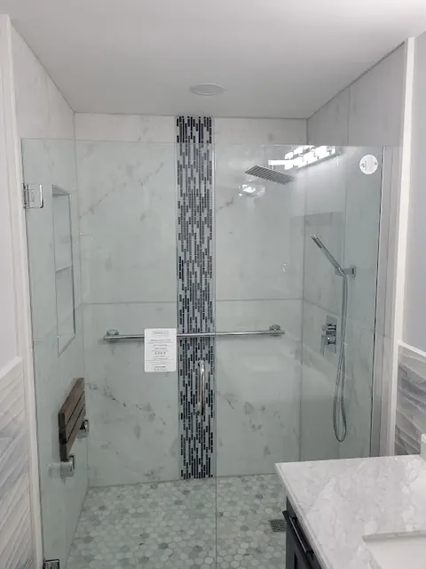 Walk-in glass shower with mosaic accent stripe