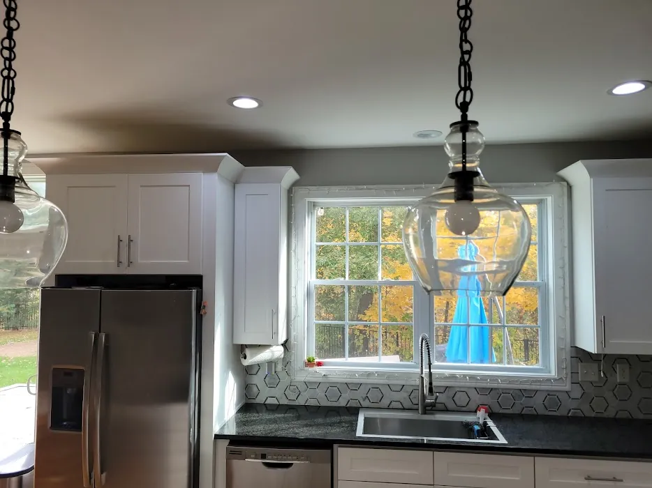 White shaker kitchen with black countertops